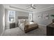 Light-filled main bedroom features trey ceilings, a ceiling fan, and large windows at 145 Leisure Ln # 12, Louisburg, NC 27549