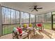 Screened-in porch with comfortable seating area and ceiling fan perfect for relaxing outdoors while enjoying the wooded view at 145 Leisure Ln # 12, Louisburg, NC 27549
