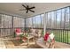 Inviting screened-in porch with comfortable seating and overhead fan, designed for outdoor relaxation and enjoyment at 145 Leisure Ln # 12, Louisburg, NC 27549