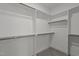 Walk-in closet with shelving, racks and carpeted floor; ready for organization at 145 Leisure Ln # 12, Louisburg, NC 27549