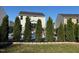 Landscaped backyard showcasing a well-maintained lawn, privacy fence, and house at 150 Sherrill Place Ln, Garner, NC 27529