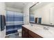 Bathroom featuring double sinks, modern fixtures, and a shower with a blue striped curtain at 150 Sherrill Place Ln, Garner, NC 27529