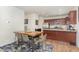 Open dining area features a wooden table with seating, connected to kitchen with granite countertops at 150 Sherrill Place Ln, Garner, NC 27529