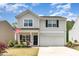 Charming two-story home featuring well-maintained landscaping, and a two car garage at 150 Sherrill Place Ln, Garner, NC 27529