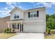 Well-maintained two-story house with an attached two-car garage, and manicured lawn at 150 Sherrill Place Ln, Garner, NC 27529