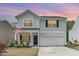 Charming two-story home featuring a well-manicured lawn, a two-car garage, and classic architectural details at 150 Sherrill Place Ln, Garner, NC 27529