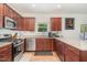 A well-equipped kitchen with stainless steel appliances and wood cabinets provides a delightful cooking experience at 150 Sherrill Place Ln, Garner, NC 27529