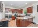 Bright kitchen features wood floors, a granite-topped island and matching countertops with stainless steel appliances at 150 Sherrill Place Ln, Garner, NC 27529