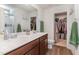 Main bathroom with double sinks, walk-in shower, and a spacious closet at 150 Sherrill Place Ln, Garner, NC 27529