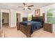 Bright main bedroom offers a spacious layout, a plush bed, and dual windows at 150 Sherrill Place Ln, Garner, NC 27529