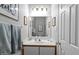 Bathroom featuring a white vanity, framed mirror, and grey towels at 1601 Dunraven Dr, Raleigh, NC 27612