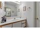 Bright bathroom with a large mirror, and wood-trimmed cabinetry at 1601 Dunraven Dr, Raleigh, NC 27612