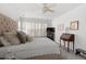 Comfortable bedroom features a large bed, shutters, and ceiling fan at 1601 Dunraven Dr, Raleigh, NC 27612