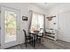 Cozy breakfast nook with table, chairs, shelving, and a window overlooking the deck at 1601 Dunraven Dr, Raleigh, NC 27612