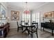 Dining room with a wood table, chairs, shuttered windows, and decorative lighting at 1601 Dunraven Dr, Raleigh, NC 27612