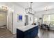 Spacious kitchen with blue cabinets, white countertops, island, and modern chandelier at 1601 Dunraven Dr, Raleigh, NC 27612