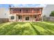 View of the backyard, the home's siding, and two-story covered deck at 2024 Spring Creek Dr, Durham, NC 27704