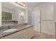 Well lit bathroom featuring double granite vanity, tub, and walk-in shower at 2024 Spring Creek Dr, Durham, NC 27704