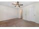 Spacious bedroom featuring neutral carpeting and a ceiling fan with light fixture at 2024 Spring Creek Dr, Durham, NC 27704