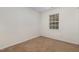 Carpeted bedroom with a window and neutral painted walls at 2024 Spring Creek Dr, Durham, NC 27704