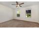 Spacious bedroom with carpet, two windows, and ceiling fan at 2024 Spring Creek Dr, Durham, NC 27704