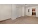 View of carpeted bedroom featuring closet with double doors and view to kitchen at 2024 Spring Creek Dr, Durham, NC 27704
