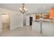 Bright kitchen with white floors and tile backsplash, granite countertops, island, and modern lighting at 2024 Spring Creek Dr, Durham, NC 27704