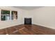 Cozy living room with hardwood floors, neutral walls, a fireplace and one large window at 2024 Spring Creek Dr, Durham, NC 27704
