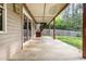 Covered patio with wooden support posts, stairway, and an attached home at 2024 Spring Creek Dr, Durham, NC 27704