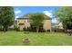 Expansive backyard with a fire pit, screened porch, lush lawn, and mature trees at 2053 Monthaven Dr, Wake Forest, NC 27587