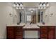 Bathroom featuring double vanity, granite counters, dark wood cabinets, and access to shower and bathtub at 2053 Monthaven Dr, Wake Forest, NC 27587
