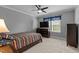 Bedroom with neutral walls, carpet, ceiling fan, and window dressed with blue cornice valance at 2053 Monthaven Dr, Wake Forest, NC 27587