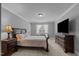 Bedroom featuring neutral walls, carpet, side tables, and dark wood furniture at 2053 Monthaven Dr, Wake Forest, NC 27587