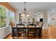 A dining room with a chandelier, a bay window, and an open view to the living room at 2053 Monthaven Dr, Wake Forest, NC 27587
