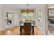 A dining room with a table set for six, a bay window and a door to the back yard at 2053 Monthaven Dr, Wake Forest, NC 27587
