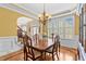 This dining room features a chandelier, and windows with an entrance to another room at 2053 Monthaven Dr, Wake Forest, NC 27587