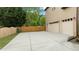 Large driveway with a two-car garage and a wooden fence at 2053 Monthaven Dr, Wake Forest, NC 27587