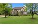 Charming two-story home featuring a well-maintained lawn, and lush trees at 2053 Monthaven Dr, Wake Forest, NC 27587