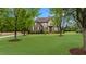 Beautiful two-story home with manicured lawn and mature trees on a sunny day at 2053 Monthaven Dr, Wake Forest, NC 27587