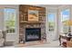 Cozy living room featuring a stone fireplace with windows on each side at 2053 Monthaven Dr, Wake Forest, NC 27587