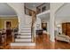Elegant foyer with hardwood floors, staircase with wrought iron spindles and arched entryways at 2053 Monthaven Dr, Wake Forest, NC 27587
