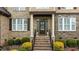 Charming front entrance with brick steps, decorative columns, and a beautiful front door at 2053 Monthaven Dr, Wake Forest, NC 27587
