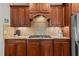 A kitchen featuring warm wood cabinets, granite countertops and a mosaic tile backsplash at 2053 Monthaven Dr, Wake Forest, NC 27587