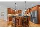Spacious kitchen with island, wooden cabinets, granite countertops, and stainless steel appliances at 2053 Monthaven Dr, Wake Forest, NC 27587