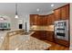 A kitchen showcasing granite countertops, stainless steel appliances, and warm wood cabinetry at 2053 Monthaven Dr, Wake Forest, NC 27587