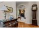 View of a beautiful stone fireplace from the arched hallway entrance with a hardwood floor at 2053 Monthaven Dr, Wake Forest, NC 27587
