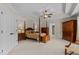 A large main bedroom with a tray ceiling, dark wood furniture and carpeted floors at 2053 Monthaven Dr, Wake Forest, NC 27587