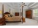 A main bedroom with a tray ceiling, carpeted floors and a four-poster bed at 2053 Monthaven Dr, Wake Forest, NC 27587