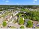 An aerial view of the neighborhood showcasing well-maintained homes, mature trees, and a tranquil pond at 209 Oswego Ct, Morrisville, NC 27560