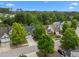 An aerial view showcases tree-lined streets and beautiful homes in a residential neighborhood at 209 Oswego Ct, Morrisville, NC 27560